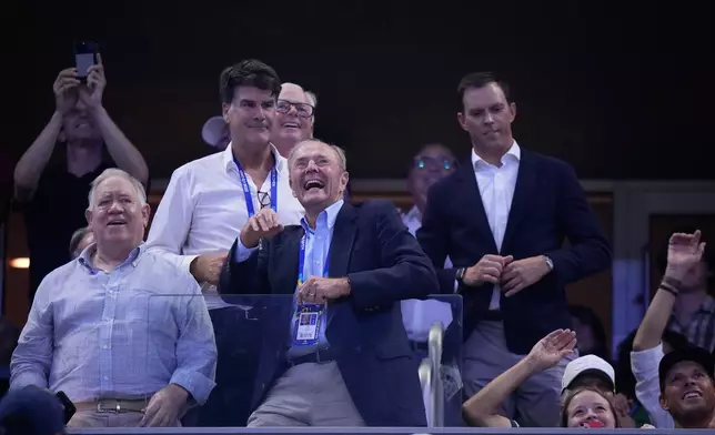 Dick Gould, center, a 17-time champion coach at Stanford, looks on as he is honored at the U.S. Open tennis championships, Saturday, Sept. 5, 2026, in New York. (AP Photo/Frank Franklin II)