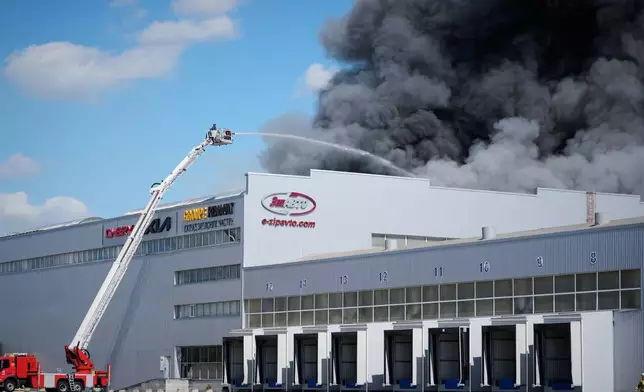 Firefighters put out a fire at warehouse stores after a Russian air attack in Kyiv, Ukraine, Wednesday, Sept. 2, 2026. (AP Photo/Efrem Lukatsky)