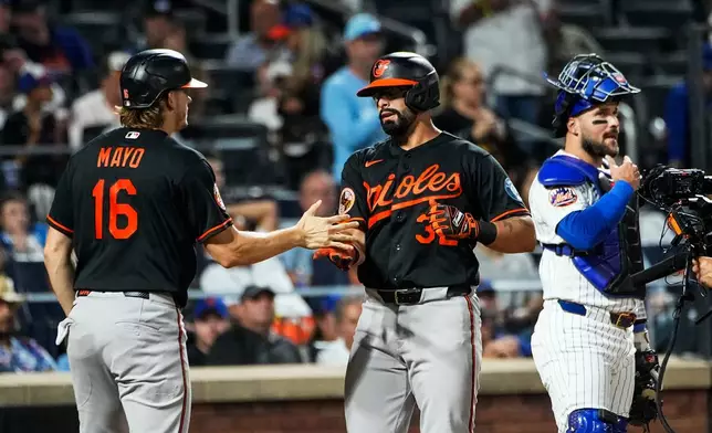 Baltimore Orioles Christian Encarnacion-Strand (32) celebrates with teammate Coby Mayo (16) after hitting a two-run home run during the third inning of a baseball game against the New York Mets, Wednesday, Sept. 16, 2026, in New York. (AP Photo/Eduardo Munoz Alvarez)