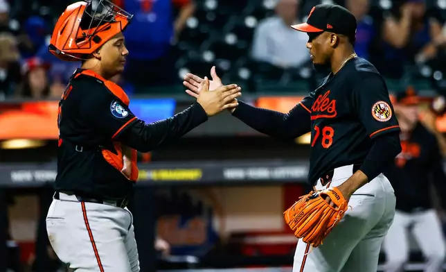 Baltimore Orioles pitcher Yennier Cano (78) celebrates with catcher Samuel Basallo after defeating the New York Mets in a baseball game, Wednesday, Sept. 16, 2026, in New York. (AP Photo/Eduardo Munoz Alvarez)