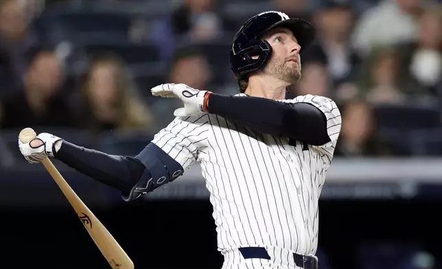 New York Yankees' Ryan McMahon watches his grand slam during the third inning of a baseball game against the Tampa Bay Rays, Wednesday, Sept. 23, 2026, in New York. (AP Photo/Adam Hunger)