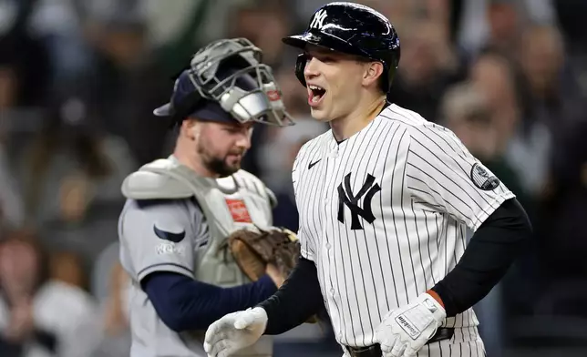 New York Yankees' Ben Rice reacts after hitting a solo home run in front of Tampa Bay Rays catcher Liam Hicks during the first inning of a baseball game Wednesday, Sept. 23, 2026, in New York. (AP Photo/Adam Hunger)