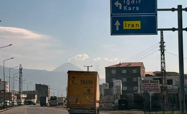 Trucks drive on the road leading to the Gurbulak border crossing on the Turkish-Iranian border in Agri province, eastern Turkey, Tuesday, Sept. 22, 2026. (AP Photo/Serra Yedikardes)