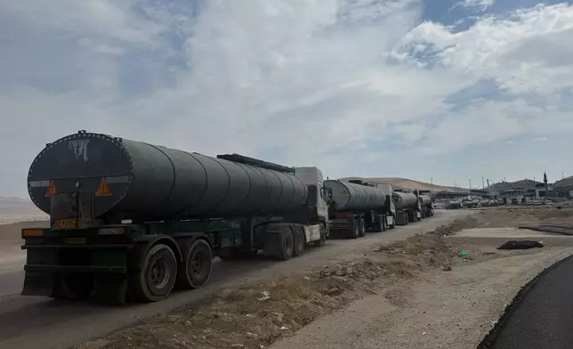 Trucks queue on the road leading to the Gurbulak border crossing on the Turkish-Iranian border in Agri province, eastern Turkey, Tuesday, Sept. 22, 2026. (AP Photo/Serra Yedikardes)