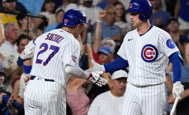 Chicago Cubs' Seiya Suzuki, left, of Japan, is congratulated by Alex Bregman, right, after hitting a solo home run during the fourth inning of a baseball game against the Milwaukee Brewers in Chicago, Monday, Aug. 31, 2026. (AP Photo/Nam Y. Huh)
