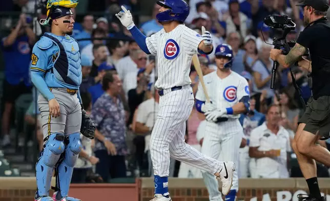 Chicago Cubs' Tyrone Taylor, center, celebrates after hitting a two-run home run during the first inning of a baseball game against the Milwaukee Brewers in Chicago, Monday, Aug. 31, 2026. (AP Photo/Nam Y. Huh)