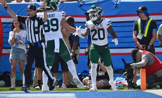 New York Jets running back Breece Hall (20) celebrates with teammate tight end Jeremy Ruckert (89) after scoring a touchdown during the second half of an NFL football game against the Tennessee Titans, Sunday, Sept. 13, 2026, in Nashville, Tenn. (AP Photo/John Amis)