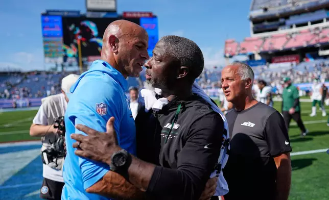 Tennessee Titans head coach Robert Saleh, left, hugs New York Jets head coach Aaron Glenn at the end of an NFL football game, Sunday, Sept. 13, 2026, in Nashville, Tenn. (AP Photo/George Walker IV)
