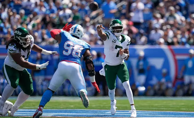 New York Jets quarterback Geno Smith (7) passes over Tennessee Titans defensive tackle Jeffery Simmons (98) during the first half of an NFL football game Sunday, Sept. 13, 2026, in Nashville, Tenn. (AP Photo/George Walker IV)