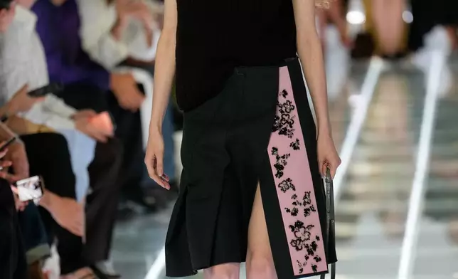 A model wears a creation part of the Prada women's Spring-Summer 2027 collection presented in Milan, Italy, Tuesday, Sept. 22, 2026. (AP Photo/Luca Bruno).