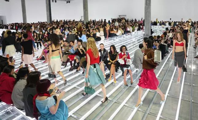 Models wear creations part of the Prada women's Spring-Summer 2027 collection presented in Milan, Italy, Tuesday, Sept. 22, 2026. (AP Photo/Luca Bruno).