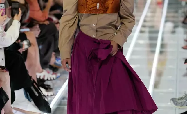 A model wears a creation part of the Prada women's Spring-Summer 2027 collection presented in Milan, Italy, Tuesday, Sept. 22, 2026. (AP Photo/Luca Bruno).