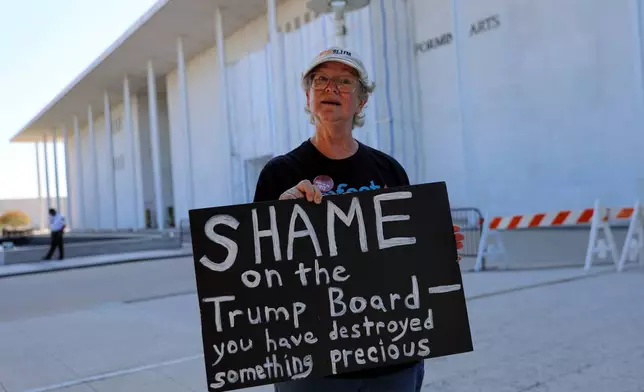 Laura Bligh of Vienna, Va., holds a protest sign outside the John F. Kennedy Center for the Performing Arts in Washington, Wednesday, Sept. 16, 2026, in Washington. (AP Photo/Rahmat Gul)