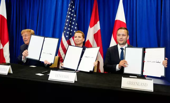 Denmark's Prime Minister Mette Frederiksen, center, Greenland's Prime Minister Jens-Frederik Nielsen, right, and US President Donald Trump at the signing ceremony of a security deal between the U.S., Denmark and Greenland at United Nations headquarters, Tuesday, Sept. 22, 2026. (Mads Claus Rasmussen/Ritzau Scanpix via AP)