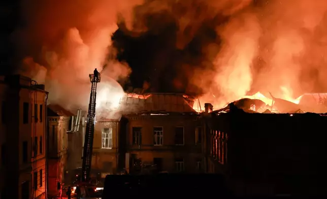 A rescue worker puts out a fire at the 120-year-old historic building of Zaporizhzhia National University after a Russian drone strike on Zaporizhzhia, Ukraine, Monday, Sept. 21, 2026. (AP Photo/Kateryna Klochko) Correction: Byline corrected to Kateryna Klochko, instead of Evgeniy Maloletka