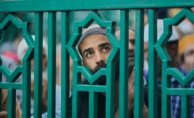 Kashmiri Muslim devotees pray as the head priest displays a relic of Sufi saint Syed Abdul Qadir Gilani during the saint's Urs, or annual commemoration, at a shrine in Srinagar, Indian-controlled Kashmir, Thursday, Sept. 24, 2026. (AP Photo/Mukhtar Khan)