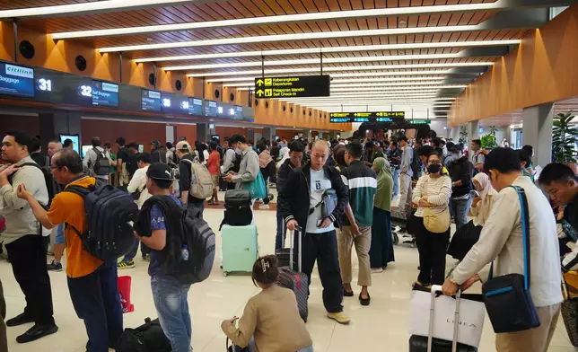 Travelers queue up for check in at Soekarno-Hatta International Airport in Tangerang, Indonesia, Sunday, Sept. 6, 2026. (AP Photo/Tatan Syuflana)