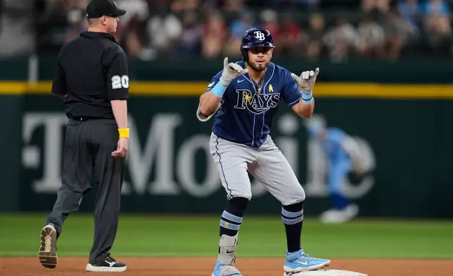 Tampa Bay Rays' Jonathan Aranda celebrates his double as umpire Ryan Wills (20) walks past during the fourth inning of a baseball game against the Texas Rangers Sunday, Sept. 6, 2026, in Arlington, Texas. (AP Photo/Tony Gutierrez)