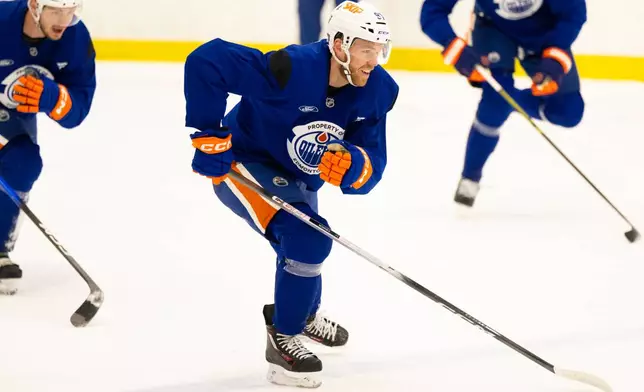 Edmonton Oilers' Connor McDavid, right, and Vasily Podkolzin skate during the NHL hockey team's training camp in Edmonton, Alberta, Thursday, Sept. 17, 2026. (John Ulan/The Canadian Press via AP)