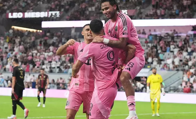 Inter Miami forward Luis Suárez (9) celebrates with Germán Berterame, left, and Telasco Segovia, right, after scoring a goal during the first half of an MLS soccer match against Atlanta United, Saturday, Sept. 5, 2026, in Miami. (AP Photo/Lynne Sladky)