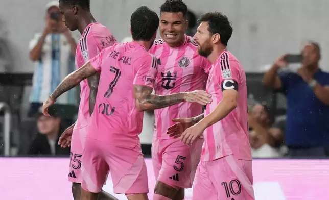 Inter Miami midfielder Casemiro (5) celebrates with midfielder Rodrigo De Paul (7) and forward Leo Messi (10) after scoring a goal during the first half of an MLS soccer match against Atlanta United, Saturday, Sept. 5, 2026, in Miami. (AP Photo/Lynne Sladky)