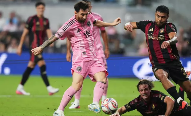 Inter Miami forward Leo Messi, left, kicks the ball as Atlanta United defender Paulo Díaz, right, defends uring the first half of an MLS soccer match, Saturday, Sept. 5, 2026, in Miami. (AP Photo/Lynne Sladky)
