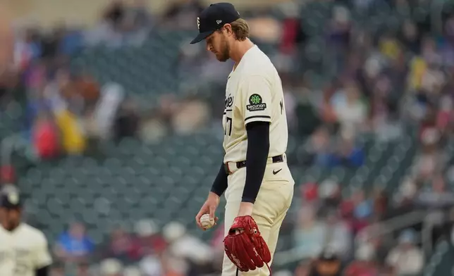Minnesota Twins starting pitcher Bailey Ober walks back to the mound after an RBI-double by Texas Rangers' Alejandro Osuna during the second inning of a baseball game, Saturday, Sept. 26, 2026, in Minneapolis. (AP Photo/Abbie Parr)