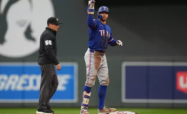 Texas Rangers' Brandon Nimmo celebrates after hitting an RBI-double during the second inning of a baseball game against the Minnesota Twins Saturday, Sept. 26, 2026, in Minneapolis. (AP Photo/Abbie Parr)