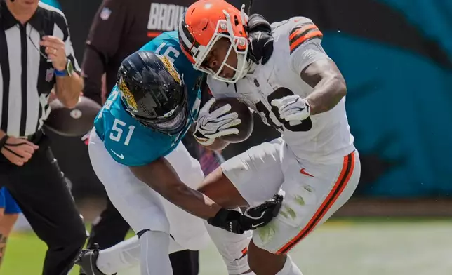 Jacksonville Jaguars linebacker Ventrell Miller (51) tackles Cleveland Browns running back Quinshon Judkins (10) in the first half of an NFL football game, Sunday, Sept. 13, 2026, in Jacksonville. (AP Photo/Mike Stewart)