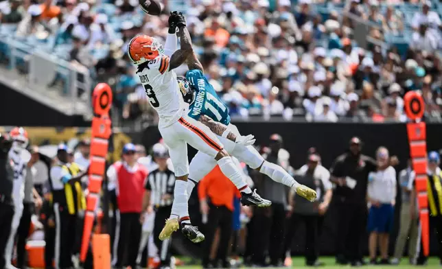 Cleveland Browns safety Grant Delpit (9) breaks up a pass intended for Jacksonville Jaguars wide receiver Parker Washington (11) in the first half of an NFL football game, Sunday, Sept. 13, 2026, in Jacksonville. (AP Photo/Phelan M. Ebenhack)