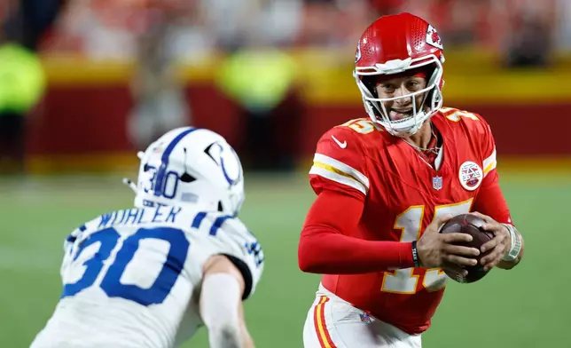Kansas City Chiefs quarterback Patrick Mahomes (15) runs for a first down as Indianapolis Colts safety Hunter Wohler (30) defends during overtime of an NFL football game Sunday, Sept. 20, 2026, in Kansas City, Mo. (AP Photo/Colin E. Braley)