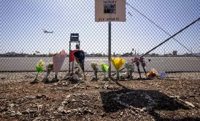 A memorial for Eliana Moreno and George Marciniw who died in a helicopter crash is seen at the site where their helicopter used to park at Whiteman Airport in Los Angeles, Wednesday, Sept. 16, 2026. (AP Photo/Ethan Swope)