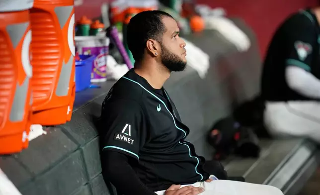 Arizona Diamondbacks starting pitcher Eduardo Rodriguez sits in the team dugout after the first inning of a baseball game against the New York Yankees, Friday, Sept. 18, 2026, in Phoenix. (AP Photo/Ross D. Franklin)