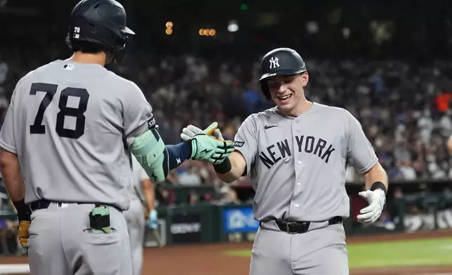 New York Yankees' Ben Rice, right, celebrates his home run against the Arizona Diamondbacks with Yankees' Spencer Jones (78) during the third inning of a baseball game, Friday, Sept. 18, 2026, in Phoenix. (AP Photo/Ross D. Franklin)