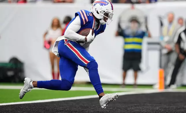 Buffalo Bills wide receiver Joshua Palmer runs the ball into the end zone for a touchdown during the second half of an NFL football game against the Houston Texans, Sunday, Sept. 13, 2026, in Houston. (AP Photo/Ashley Landis)