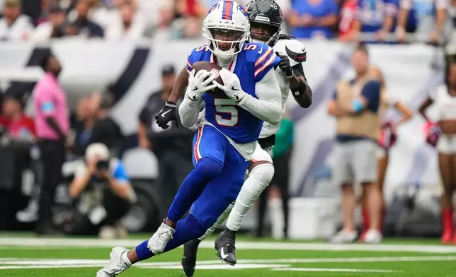 Buffalo Bills wide receiver Joshua Palmer (5) runs the ball into the end zone for a touchdown past Houston Texans cornerback Kamari Lassiter, right, during the second half of an NFL football game, Sunday, Sept. 13, 2026, in Houston. (AP Photo/Ashley Landis)