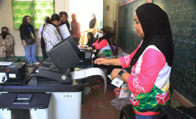 A Muslim woman votes at the Bangsamoro Autonomous Region in Muslim Mindanao parliamentary elections at a school in Lanao del Sur province, southern Philippines, Monday, Sept. 14, 2026. (AP Photo/Richel V.Umel)
