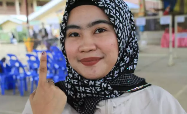 A Muslim woman voter shows the indelible ink on her fingers after voting the Bangsamoro Autonomous Region in Muslim Mindanao parliamentary elections at a school in Lanao del Sur province, southern Philippines, Monday, Sept. 14, 2026. (AP Photo/Richel V.Umel)