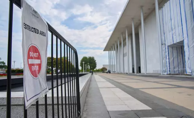 A sign directs people away from the Kennedy Center, which has been fenced off and closed to the public, Thursday, Sept. 17, 2026, in Washington. (AP Photo/Jacquelyn Martin)
