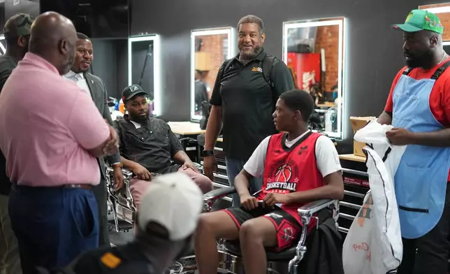Khalil Thompson, center, co-founder of Win With Black Men, leads a discussion at Philly Cuts barber shop in Philadelphia, Friday, Aug. 21, 2026. (AP Photo/Matt Rourke)