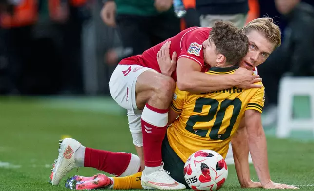 Denmark's Rasmus Hoejlund and Wales' Daniel James, back to camera, embrace during a Nations League soccer match between Denmark and Wales, in Copenhagen, Sunday, Sept. 27, 2026. (Liselotte Sabroe/Ritzau Scanpix via AP)
