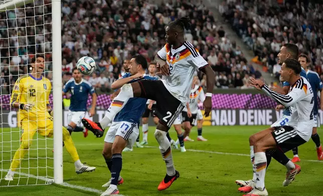 Greece's Manolis Saliakas, left, and Germany's Yann Bisseck fight for the ball during the UEFA Nations League soccer match between Germany and Greece in Augsburg, Germany, Sunday, Sept. 27, 2026. (AP Photo/Matthias Schrader)