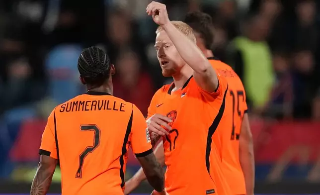 Netherlands' Mexx Meerdink celebrates with' Crysencio Summerville, left, after scoring his side's second goal during the Nations League soccer match between Serbia and the Netherlands in Belgrade, Serbia, Sunday, Sept. 27, 2026. (AP Photo/Darko Vojinovic)