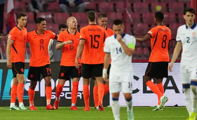 Netherlands' Mexx Meerdink, 3rd left, celebrates with his teammates after scoring the opening goal from the penalty spot during the Nations League soccer match between Serbia and the Netherlands in Belgrade, Serbia, Sunday, Sept. 27, 2026. (AP Photo/Darko Vojinovic)