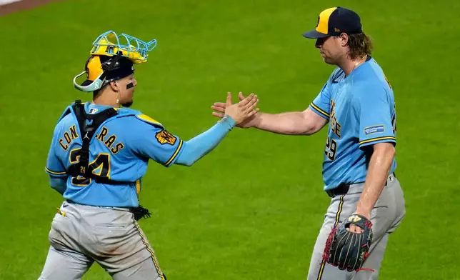 Milwaukee Brewers pitcher Trevor Megill, right, celebrates with catcher William Contreras after getting the final out of a baseball game against the Pittsburgh Pirates in Pittsburgh, Wednesday, Sept. 16, 2026. (AP Photo/Gene J. Puskar)