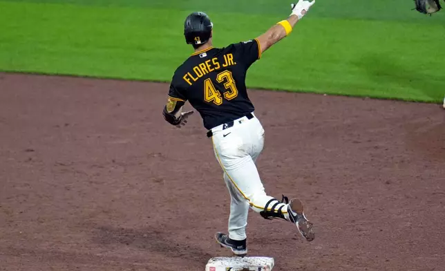 Pittsburgh Pirates' Rafael Flores Jr. celebrates as he rounds second base after hitting a solo home run off Milwaukee Brewers' Logan Henderson during the sixth inning of a baseball game in Pittsburgh, Wednesday, Sept. 16, 2026. (AP Photo/Gene J. Puskar)