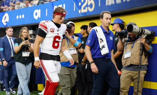 New York Giants quarterback Jaxson Dart (6) walks off the field with an injury during the first half of an NFL football game against the Los Angeles Rams in Inglewood, Calif., Monday, Sept. 21, 2026. (AP Photo/Caroline Brehman)