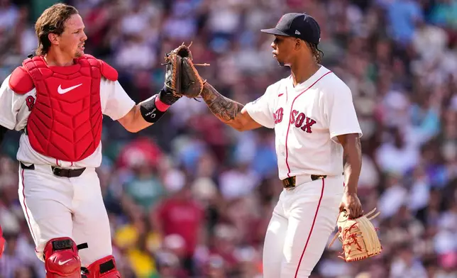 Boston Red Sox starting pitcher Brayan Bello, right, is congratulated by catcher Adley Rutschman after his scoreless outing following the fifth inning of a baseball game against the Los Angeles Angels, Monday, Sept. 7, 2026, in Boston. (AP Photo/Charles Krupa)
