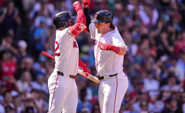 Boston Red Sox's Adley Rutschman, right, is congratulated by Wilyer Abreu after his three-run home run during the second inning of a baseball game against the Los Angeles Angels, Monday, Sept. 7, 2026, in Boston. (AP Photo/Charles Krupa)