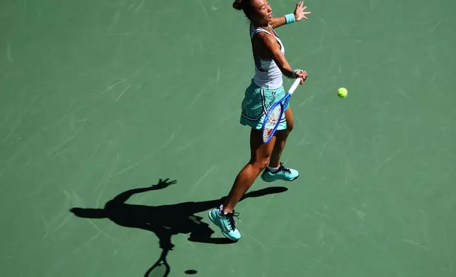 Qinwen Zheng, of China, returns the ball to Iga Swiatek, of Poland, during the fourth round of the U.S. Open tennis championships, Monday, Sept. 7, 2026, in New York. (AP Photo/Andres Kudacki)